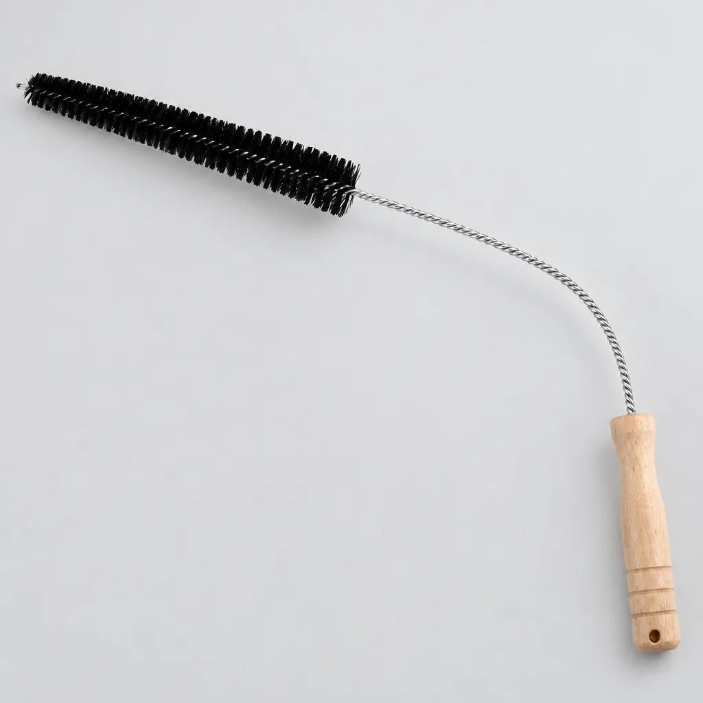 Long flexible dryer vent cleaning brush with wooden handle on a grey surface