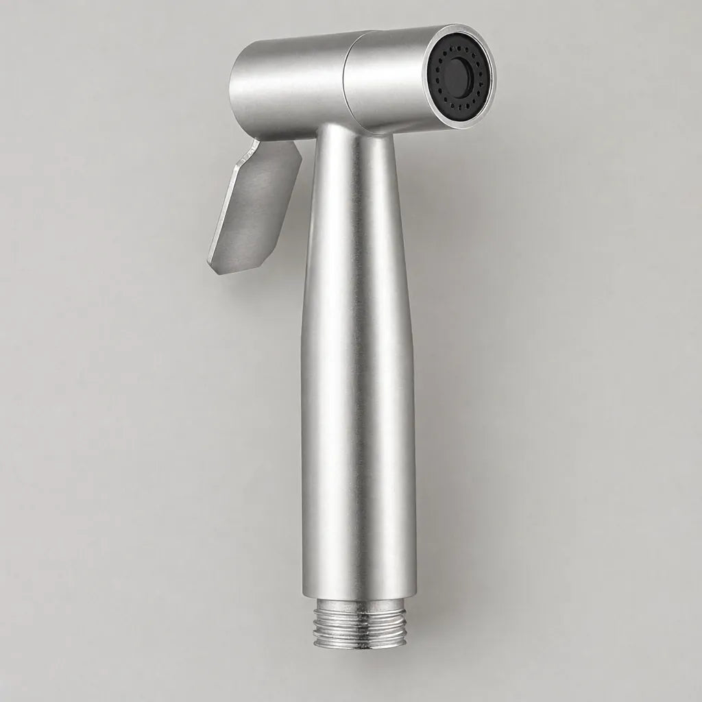 Stainless steel handheld bidet sprayer head on a light grey surface