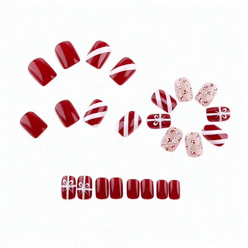 24 red Christmas press-on nails in candy cane, gift bow and plain red designs