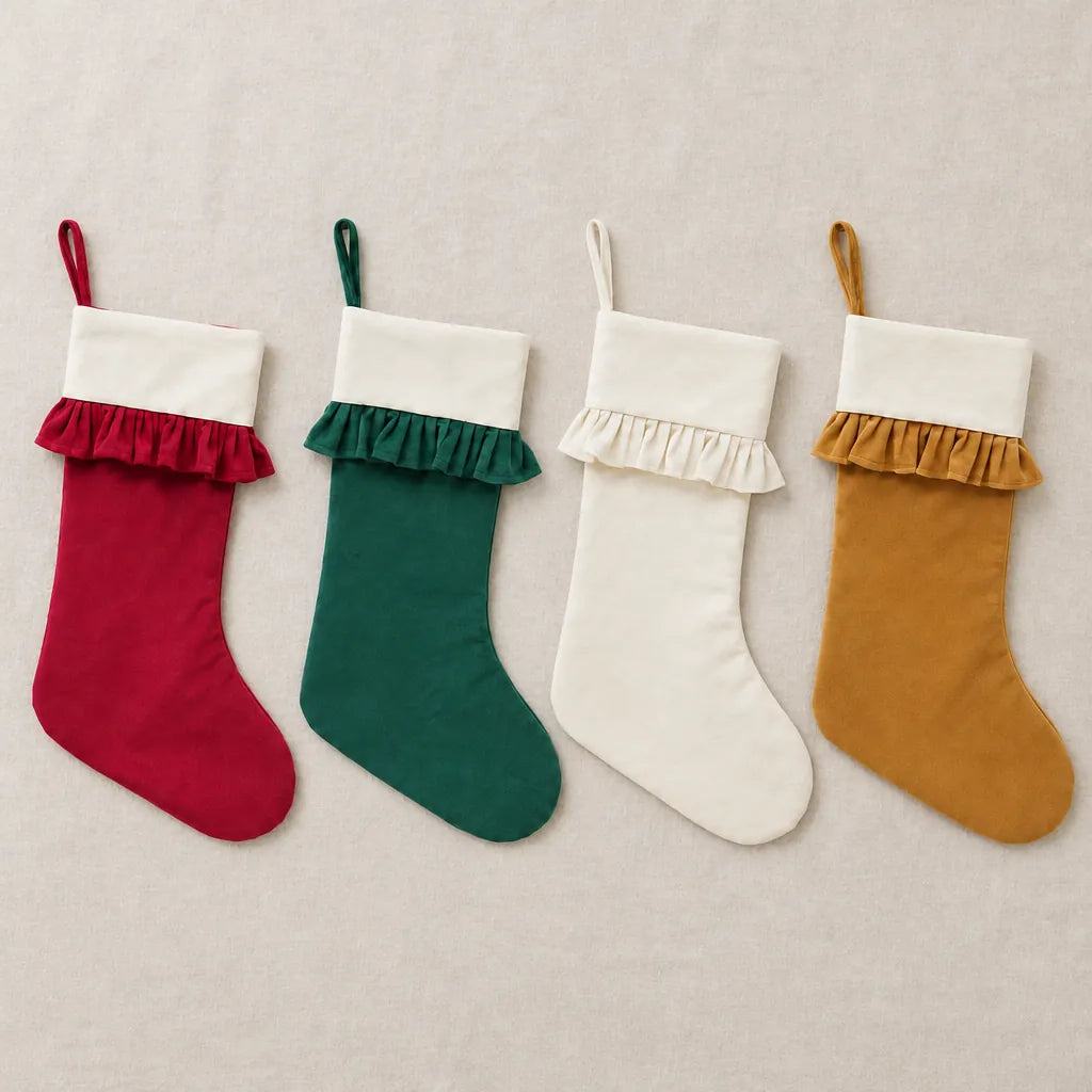 Set of 4 velvet Christmas stockings in red, green, ivory and gold laid flat