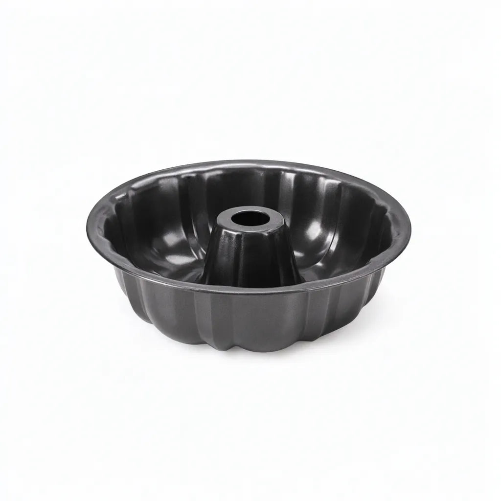 Black non-stick fluted ring cake pan on a white background