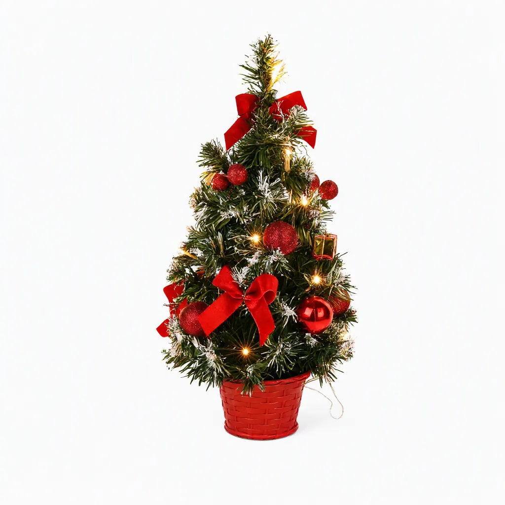 Red tabletop Christmas tree with lights, bows and baubles on white
