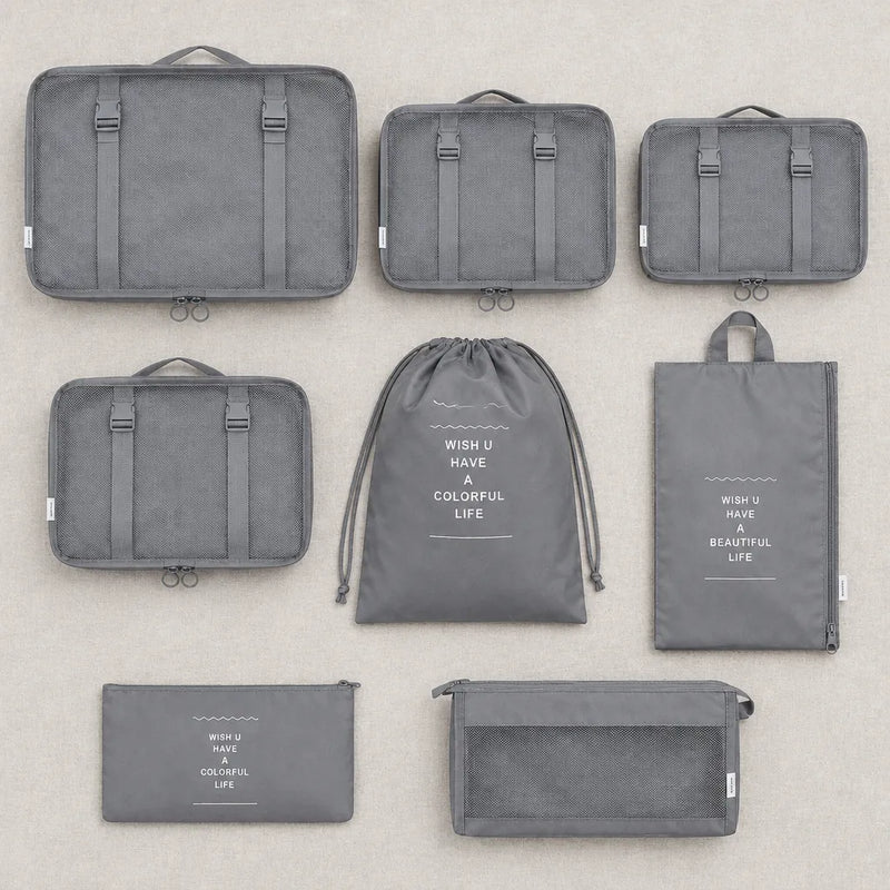 The 8-piece packing cube set laid out flat in grey