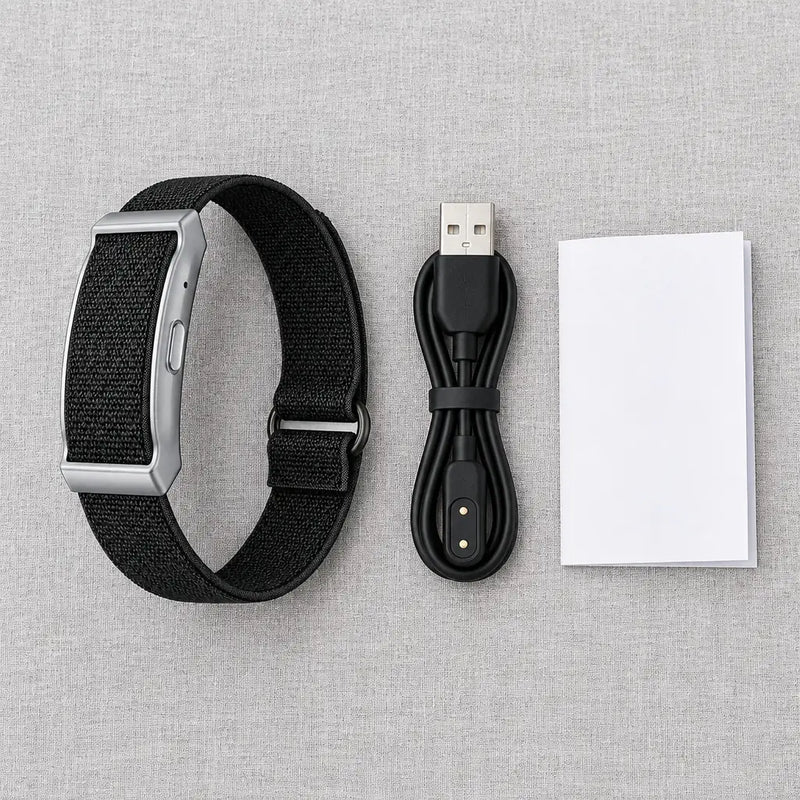 Screenless fitness tracker band with its USB charging cable and user manual on linen