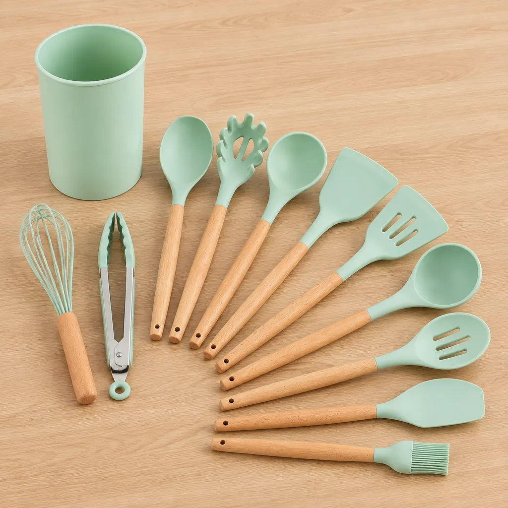 All 12 silicone kitchen utensils with wooden handles and the matching holder on a light wooden surface
