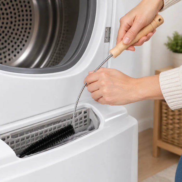 Hands sliding a flexible dryer lint brush into the lint trap slot of a dryer