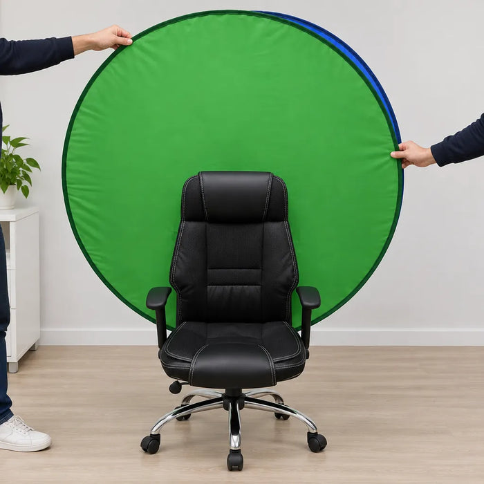 Two hands opening a collapsible green screen behind an office chair