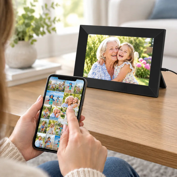 Woman choosing family photos on her phone to send to the WiFi picture frame on the table