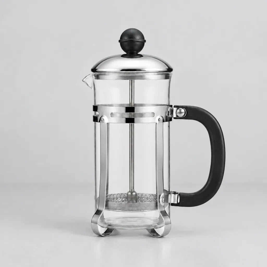 One glass French press coffee maker with lid and plunger on a light grey surface
