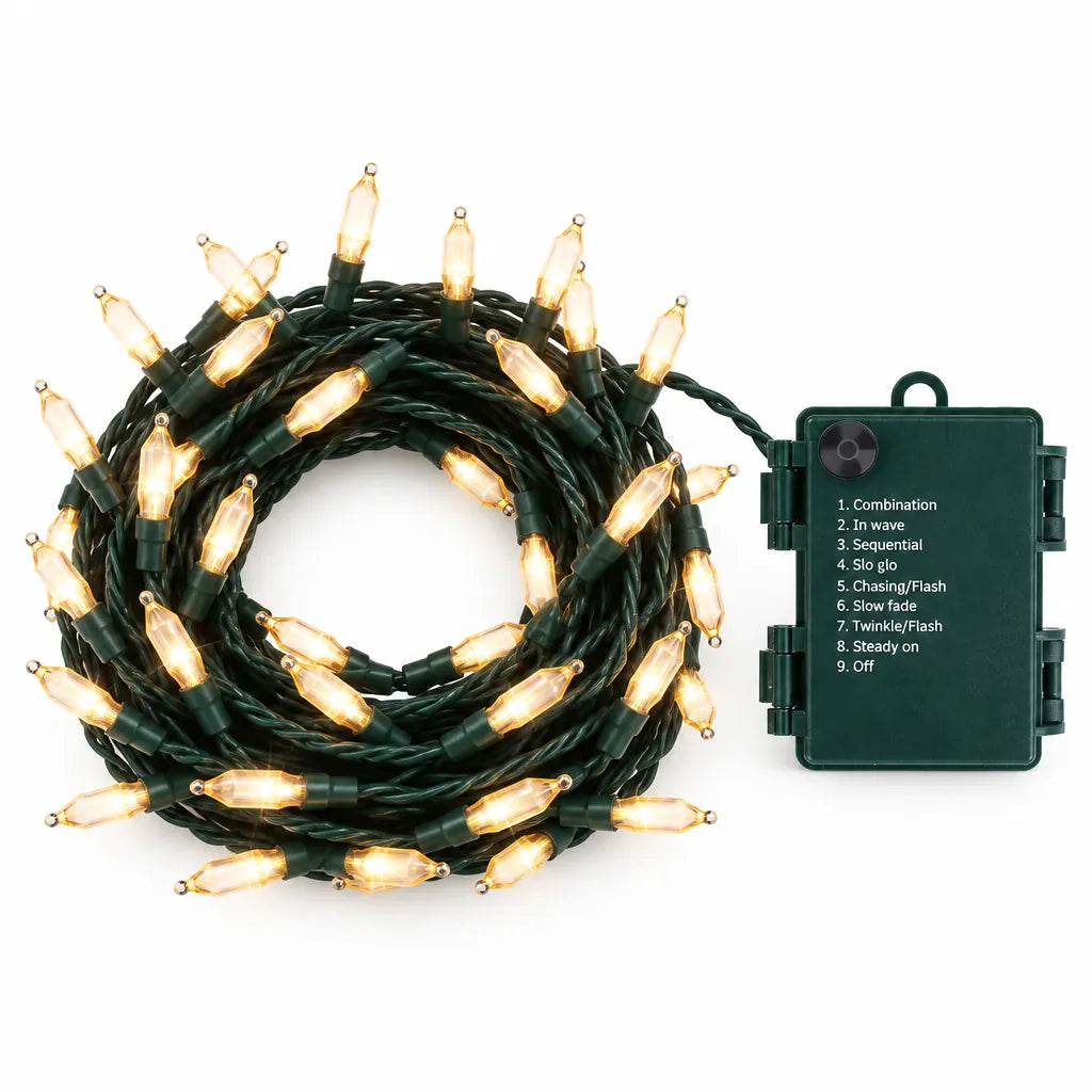Warm white battery operated outdoor Christmas lights coiled beside the dark green waterproof battery box