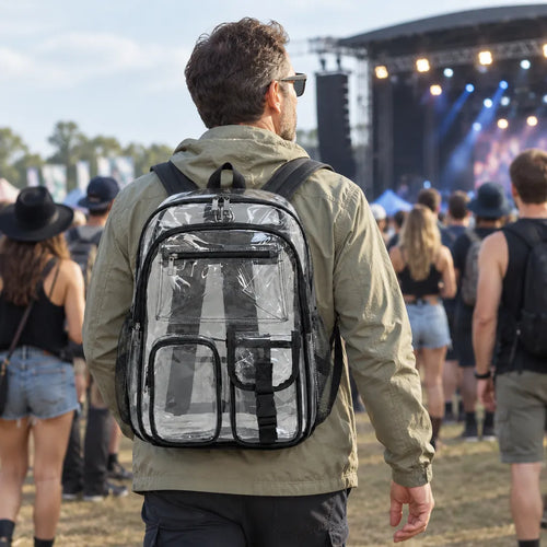 Man at an outdoor concert wearing a clear backpack