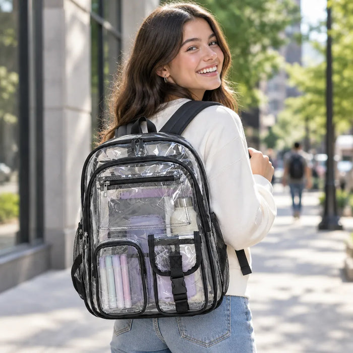 Smiling young person wearing a clear backpack on a city street