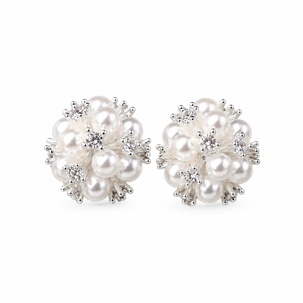 Pair of pearl flower stud earrings with zircon stones on a white background