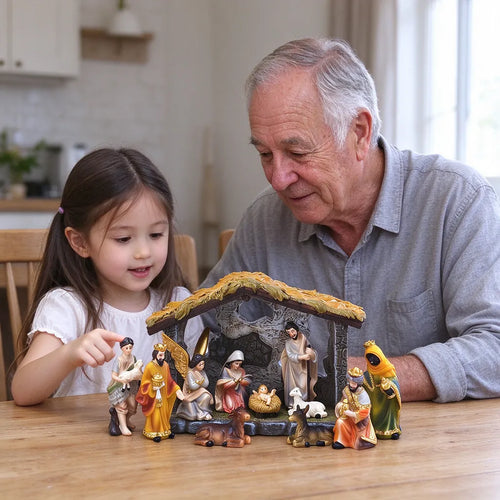 Niña y abuelo mirando un nacimiento navideño sobre la mesa del comedor