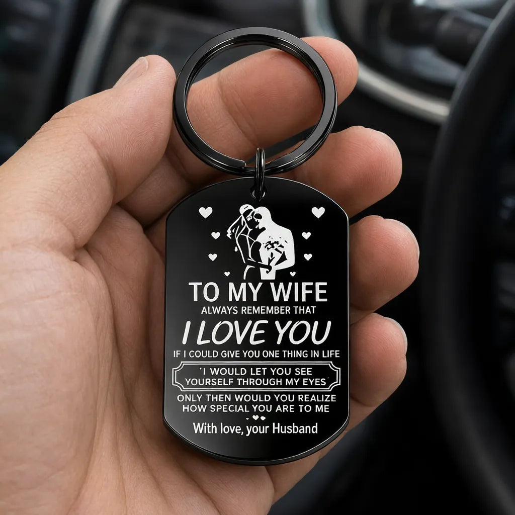 Man holding car keys with a black engraved steel keychain