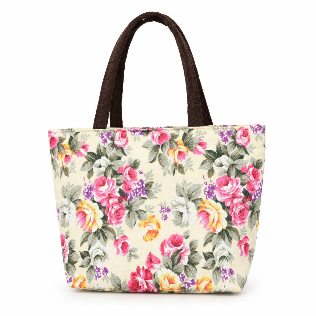 Mini canvas tote bag with cream rose print and brown handles on white