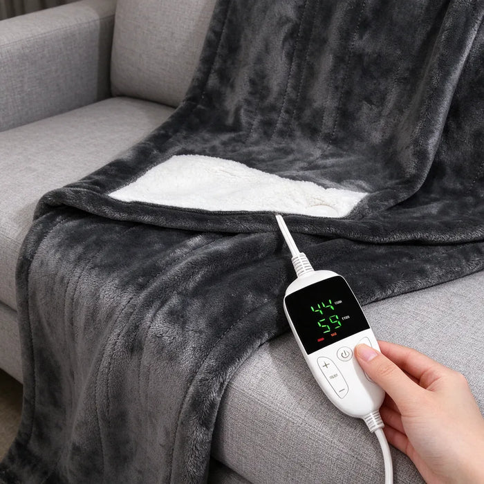 Hand pressing the plus button on the heated throw blanket controller on a sofa