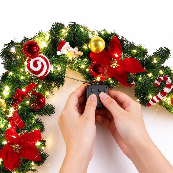 Hands switching on the battery pack of a pre-lit christmas garland