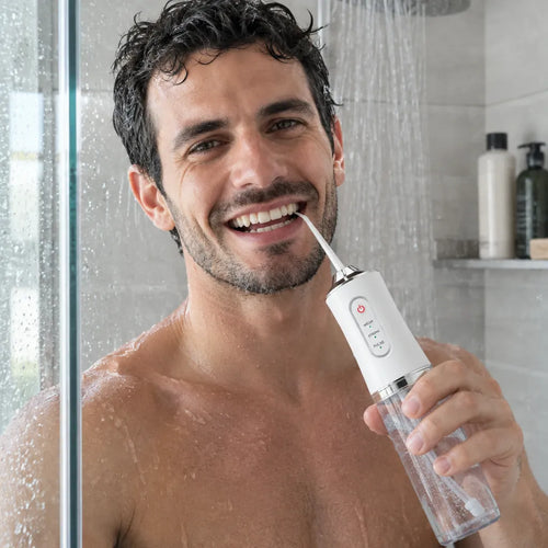 Man using a water flosser in the shower, IPX7 water resistant