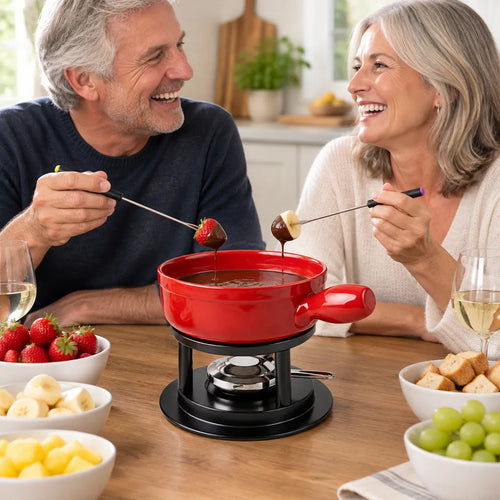 Älteres Paar lacht beim Schokoladenfondue mit Erdbeeren und Bananen