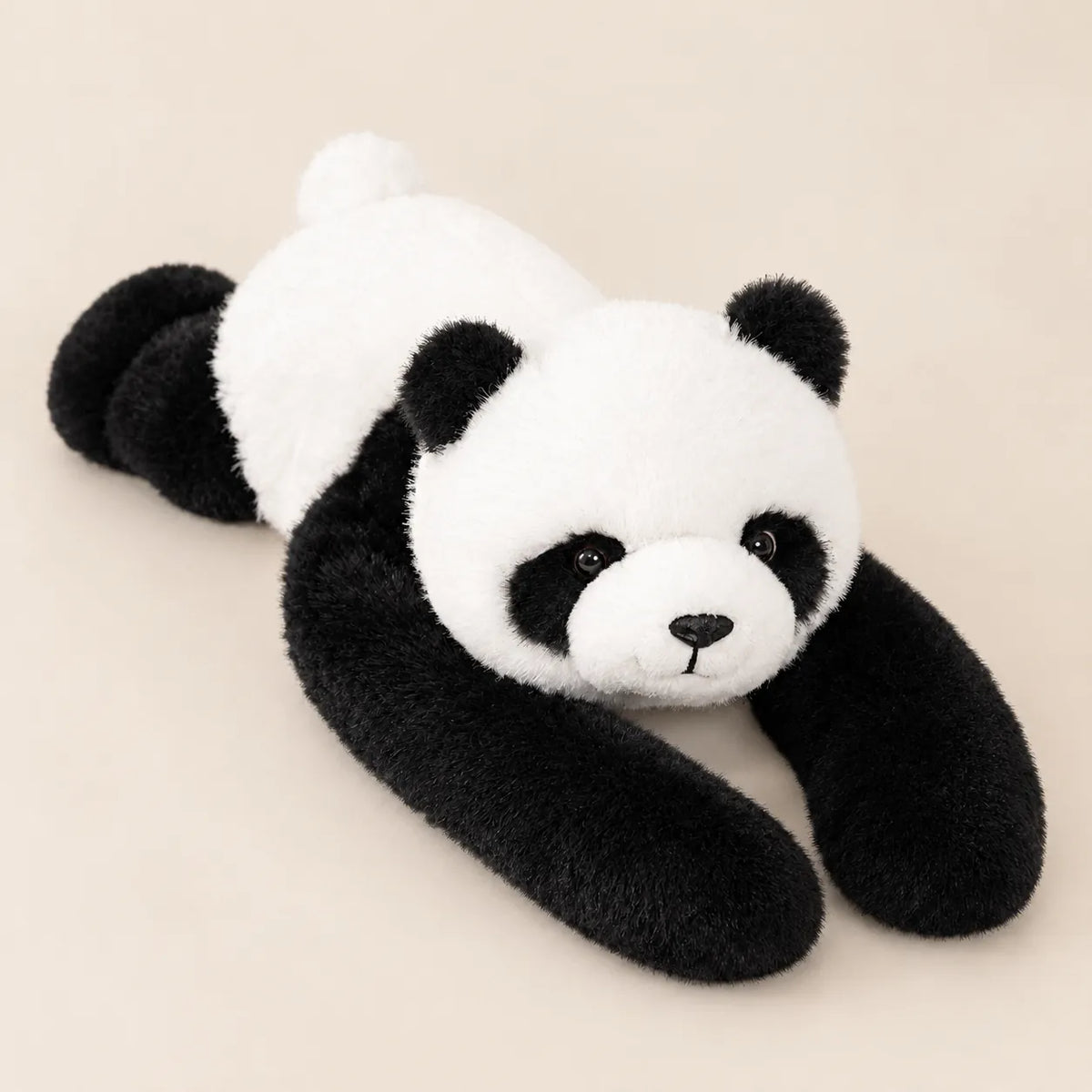 One weighted plush panda lying on a beige surface