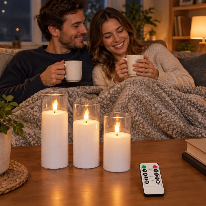 Smiling couple with mugs on a sofa next to glowing flameless candles on the coffee table