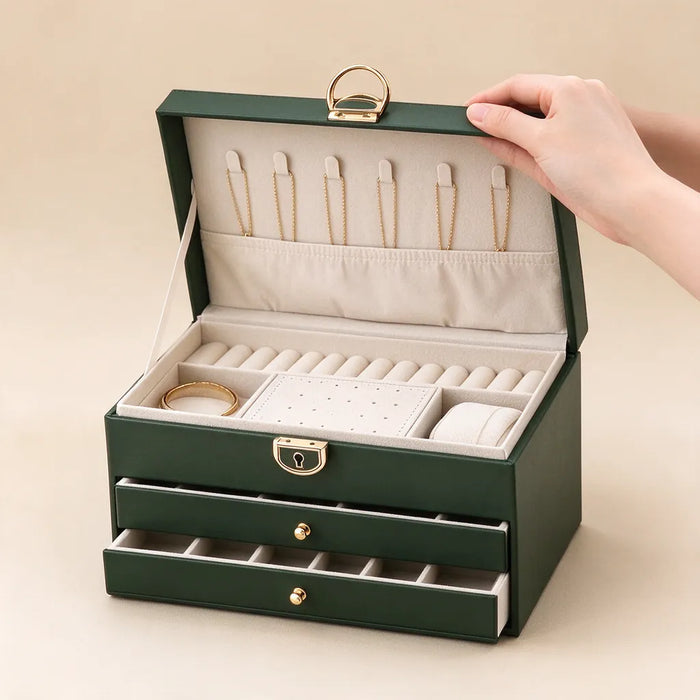 Hand lifting the lid of a green jewelry box with necklace hooks and a ring roll