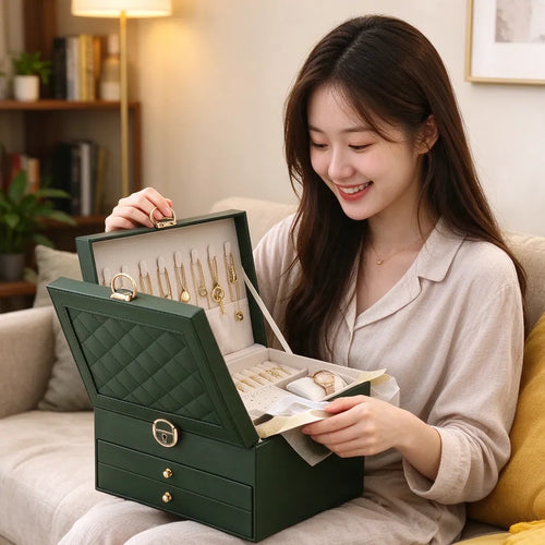 Smiling woman opening a green jewelry box as a birthday gift for her on the sofa