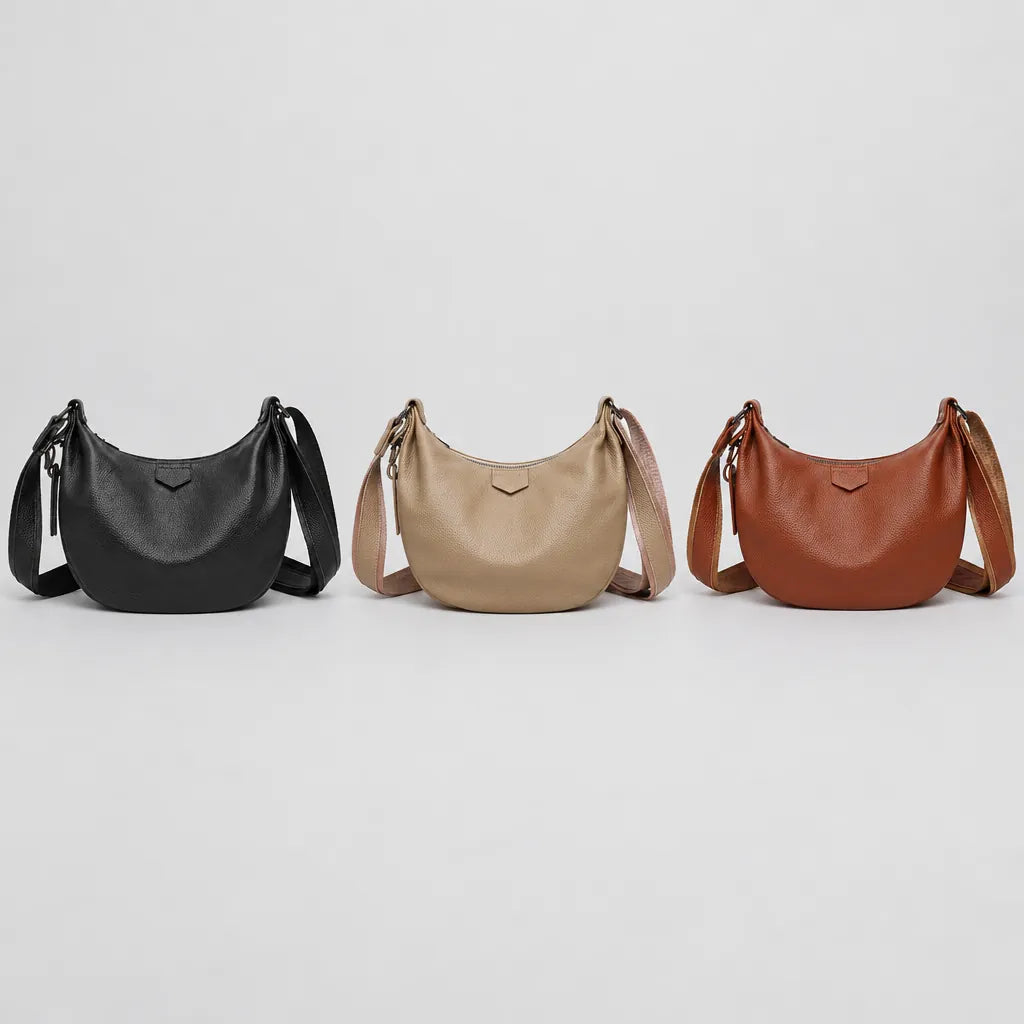 Crescent leather shoulder bag in black, khaki and reddish brown side by side