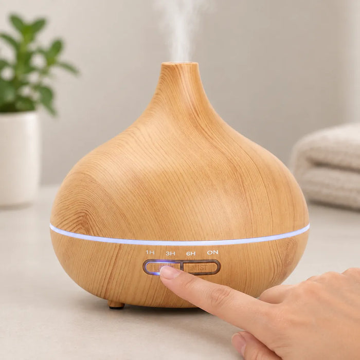 Finger pressing the mist button on a wood grain aroma diffuser