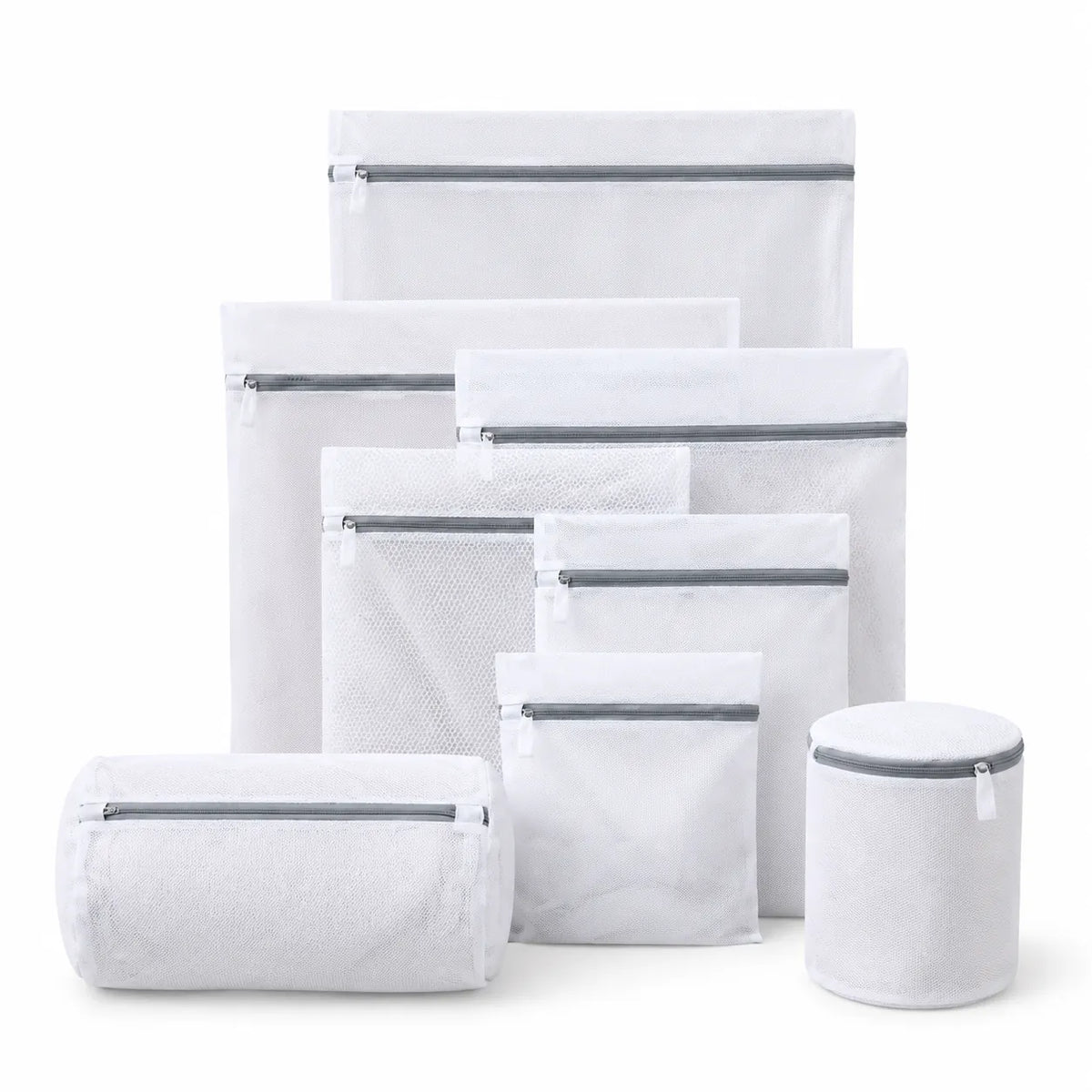Set of white mesh laundry wash bags in several sizes with grey zippers