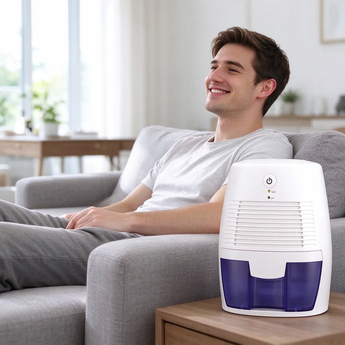 Man relaxing on a sofa next to a small dehumidifier in a dry living room