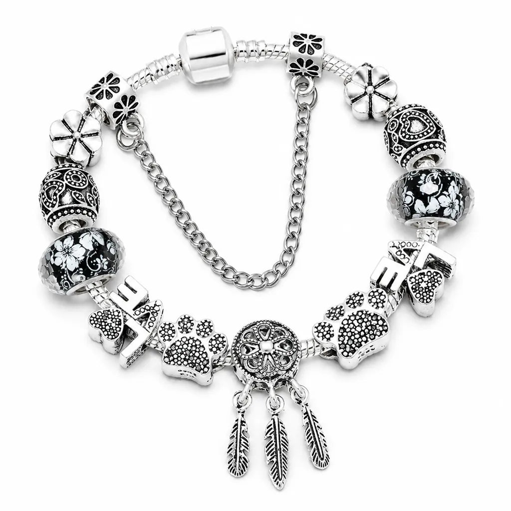 Silver charm bracelet with dream catcher, paw print and LOVE charms on a snake chain with safety chain