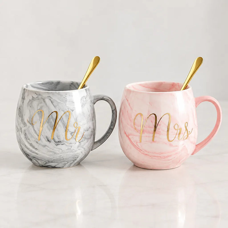 Grey Mr and pink Mrs marble mugs with a gold-tone spoon each
