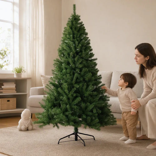 Mother and toddler beside a green artificial Christmas tree in a family room