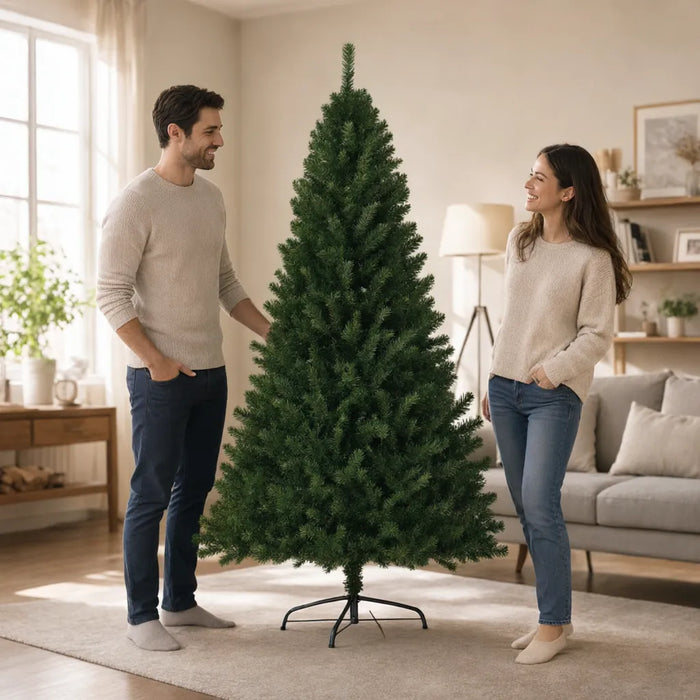 Couple smiling beside a full green artificial Christmas tree in a bright living room