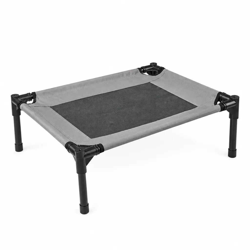 Elevated dog bed with black legs and a black mesh center on a white background