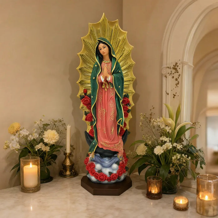 Virgen de Guadalupe statue on a home altar with flowers and candles