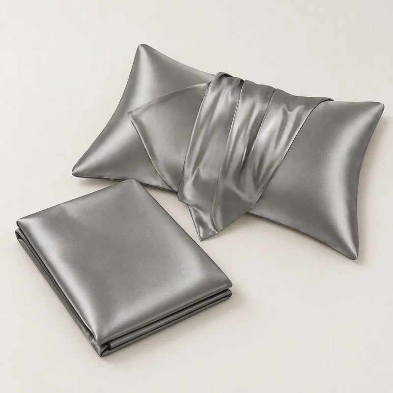 Two grey satin pillowcases, one folded and one open