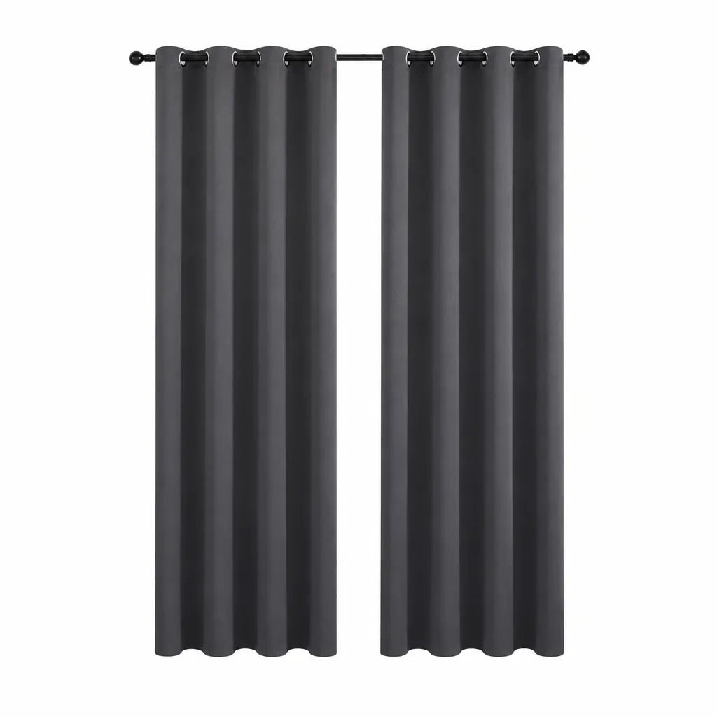 Pair of grey eyelet blackout curtains hanging on a black pole
