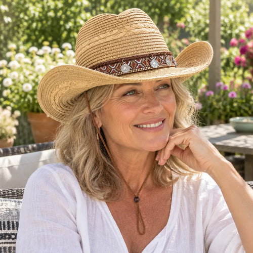 Smiling woman in a garden wearing a western straw hat